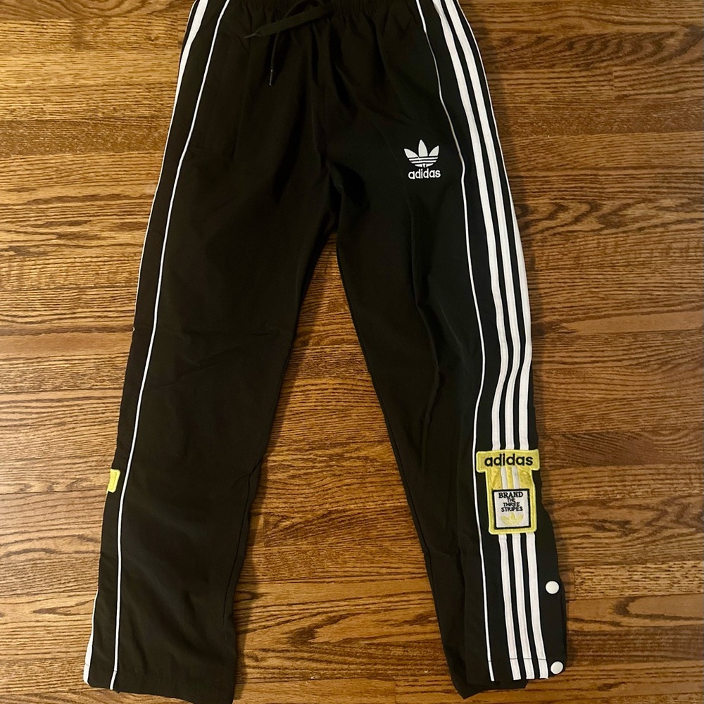 Adidas women’s Black Track Pants with White Stripes and Gold Accent is size S